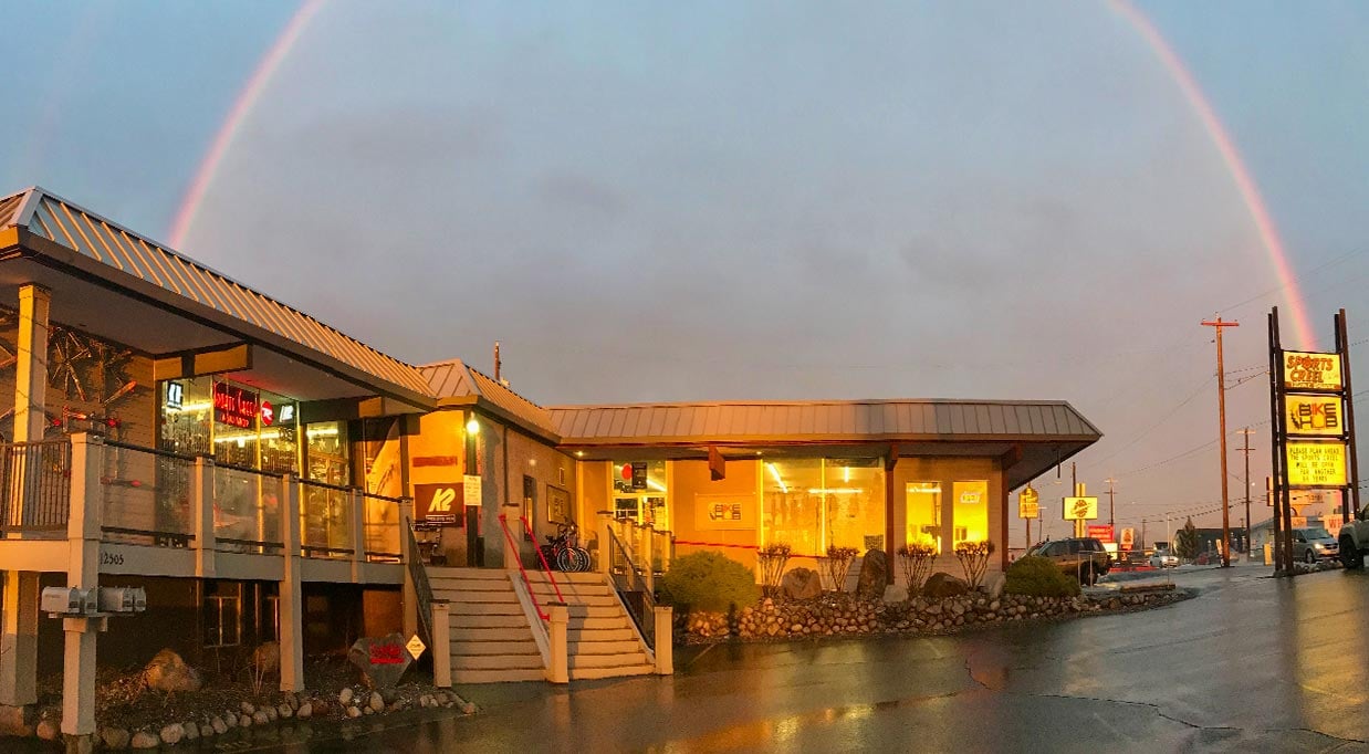 The Sports Creel is Spokane's best ski shop. This is a photo of the building in the evening with a rainbow overhead.