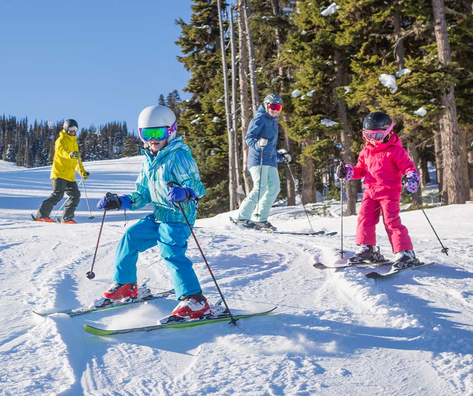 Spokane trade in your old skis for new ones family skis together in the sun